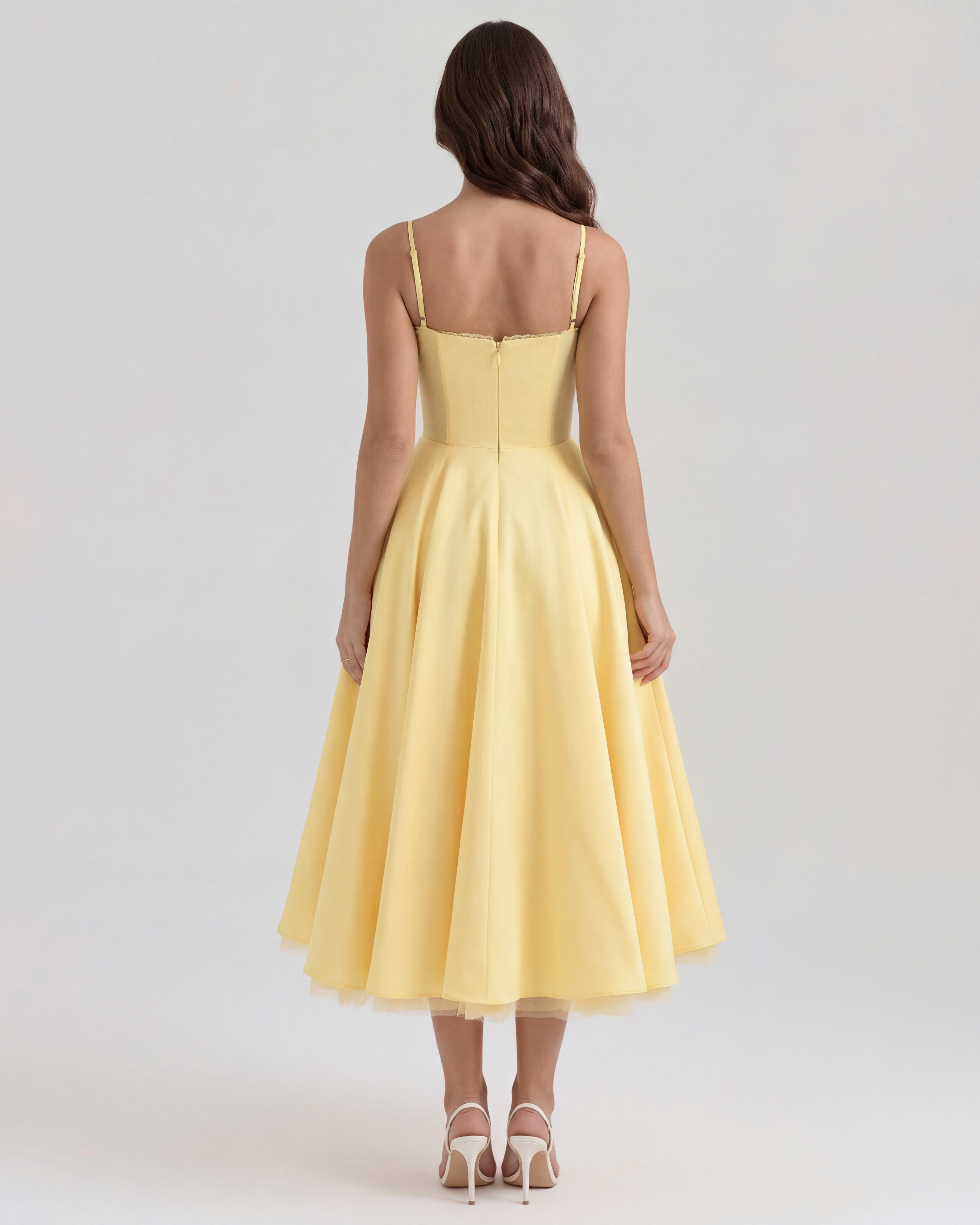Back view of butter yellow midi dress with spaghetti straps and pleated skirt