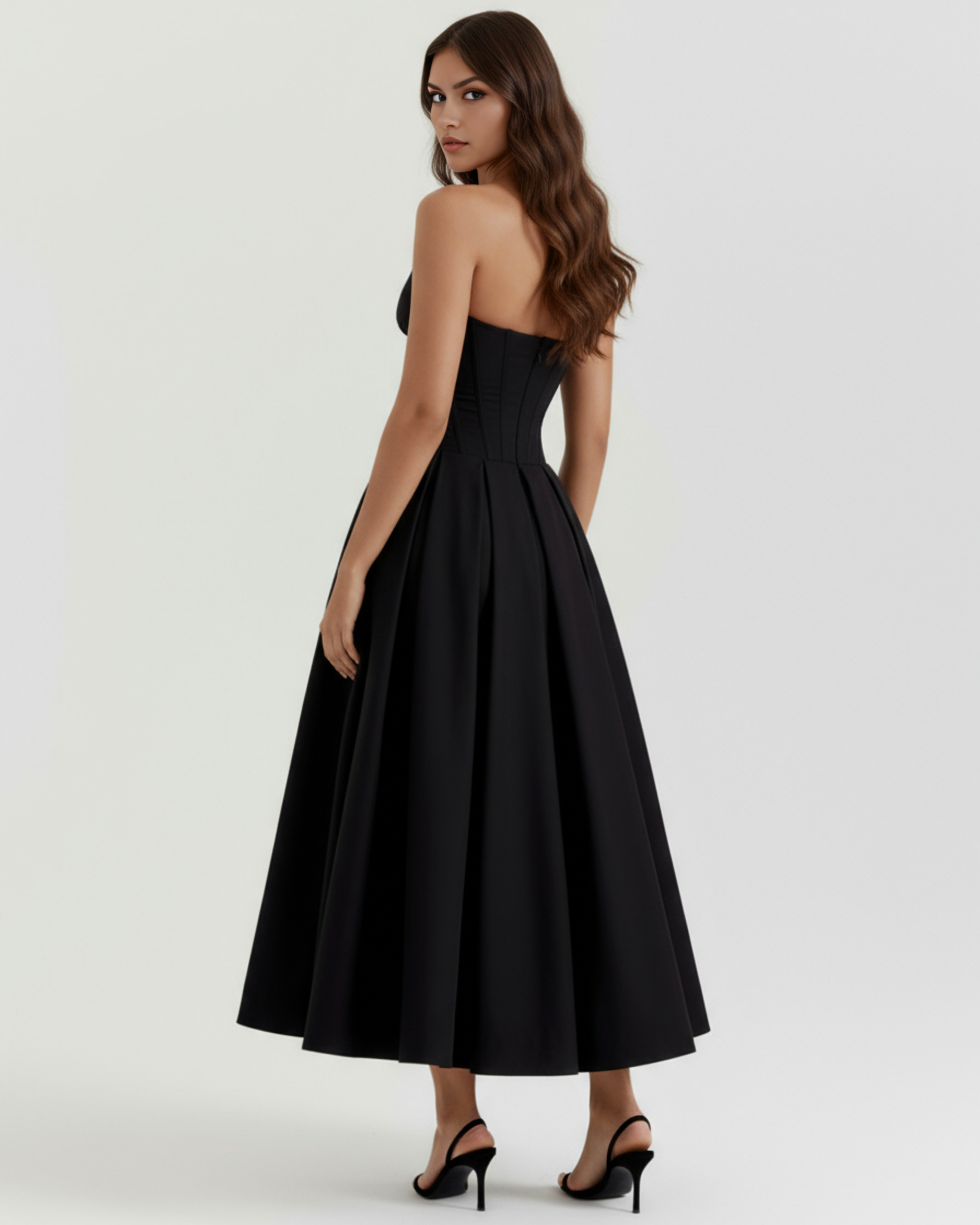 Black strapless corset midi dress shown from side, flared pleated skirt